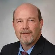 Dr. Byron May